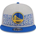 cappellino-piatto-grigio-e-blu-snapback-9fifty-draft-edition-2023-dei-golden-state-warriors-nba-di-new-era