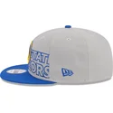 cappellino-piatto-grigio-e-blu-snapback-9fifty-draft-edition-2023-dei-golden-state-warriors-nba-di-new-era
