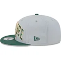 cappellino-piatto-grigio-e-verde-snapback-9fifty-tip-off-2023-dei-milwaukee-bucks-nba-di-new-era